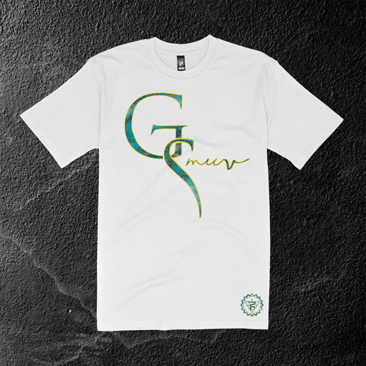 pure white t-shirt with GSMUV logo outlined in gold made out of turquoise crystal stone on a marble black and white background with a throat chakra mantra symbol at the bottom of the shirt